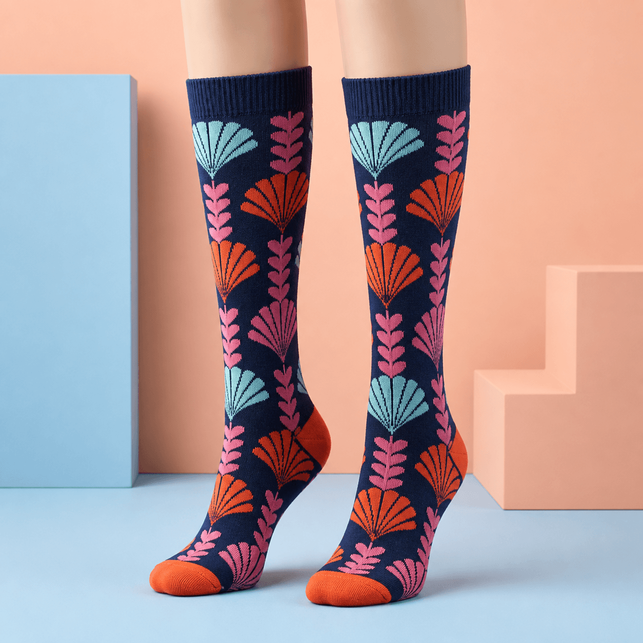 Navy custom knee-high socks with a colorful botanical knit pattern