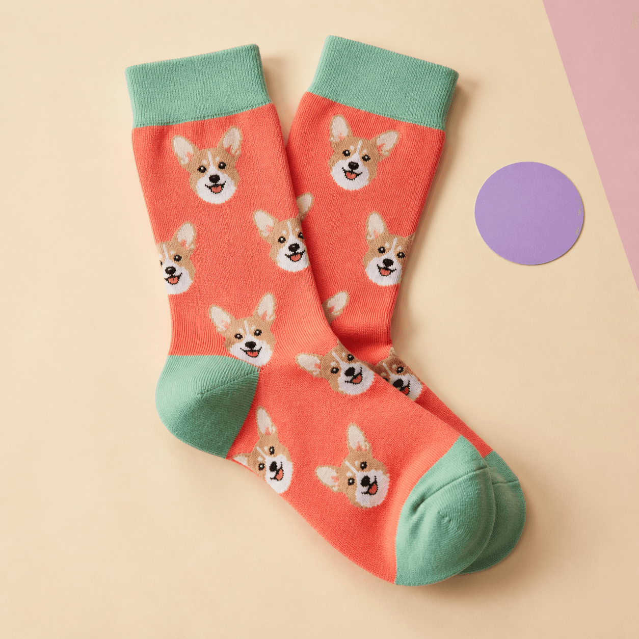 Coral custom crew socks with a knitted corgi face pattern