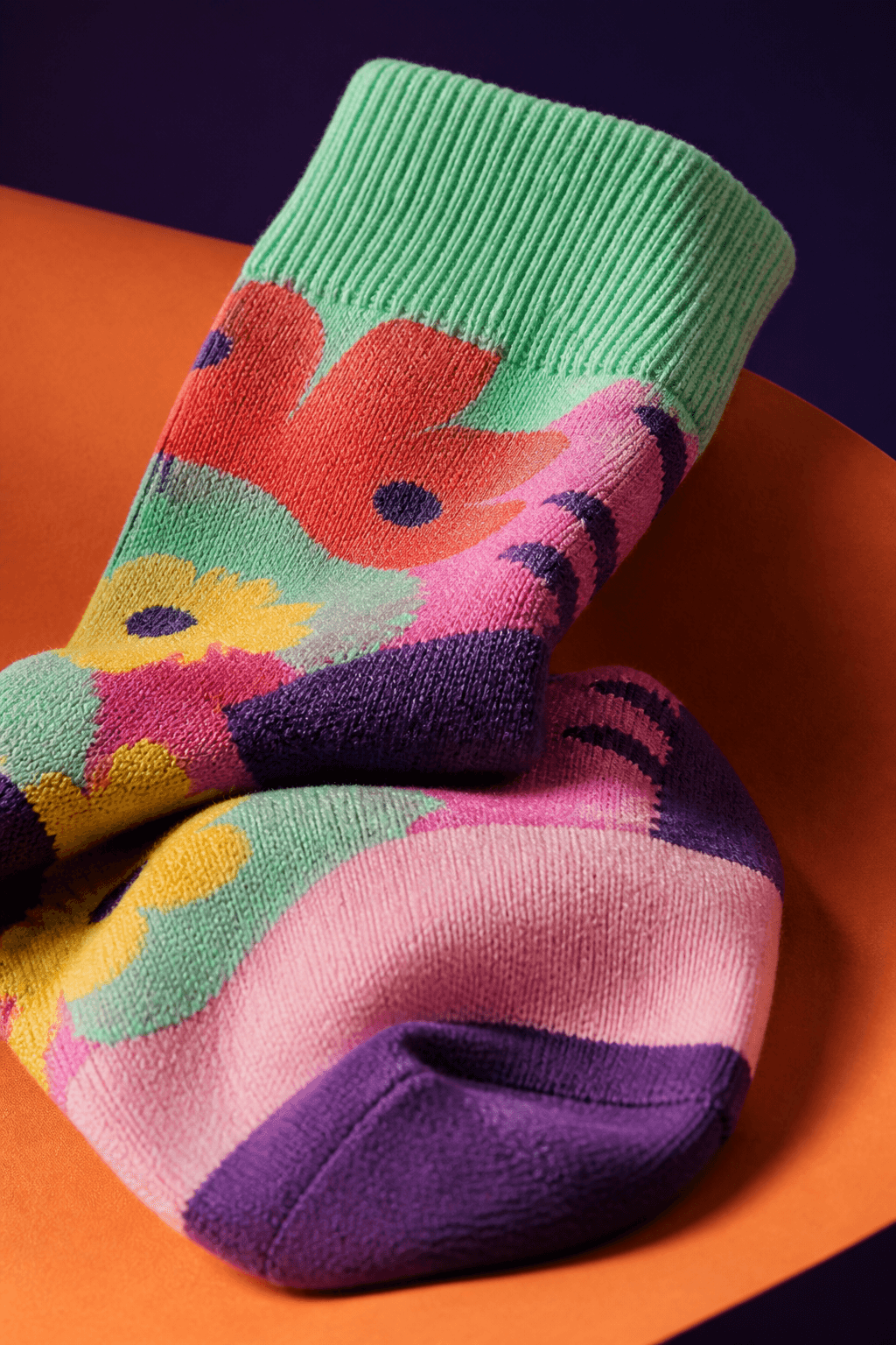 Close-up photograph showing the knit texture and stitching of colorful custom socks