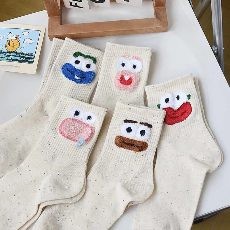 White crew socks with playful colorful face designs
