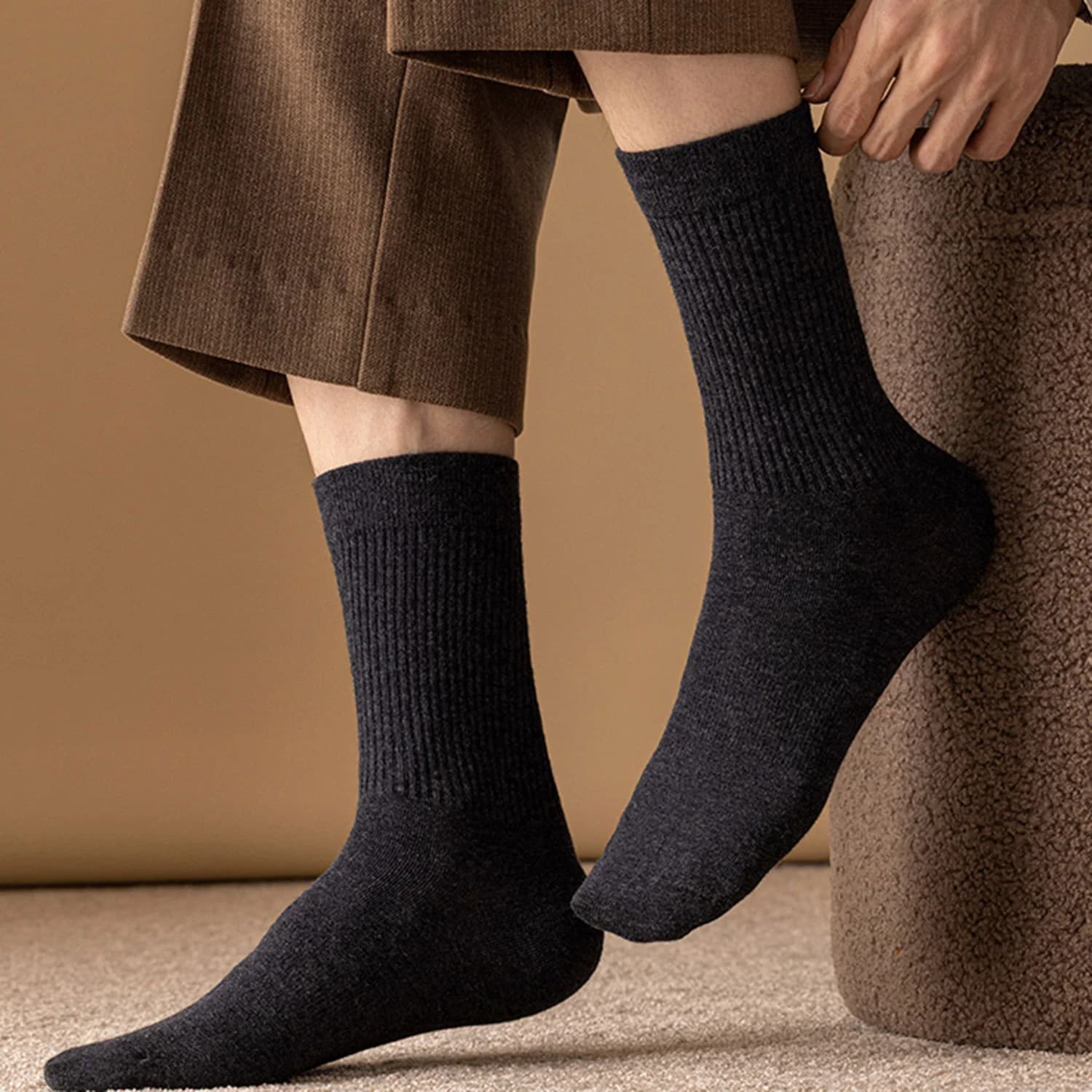 Dark textured socks worn with brown shorts