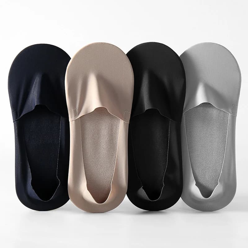 Black, beige, and gray no-show socks arranged on a light background
