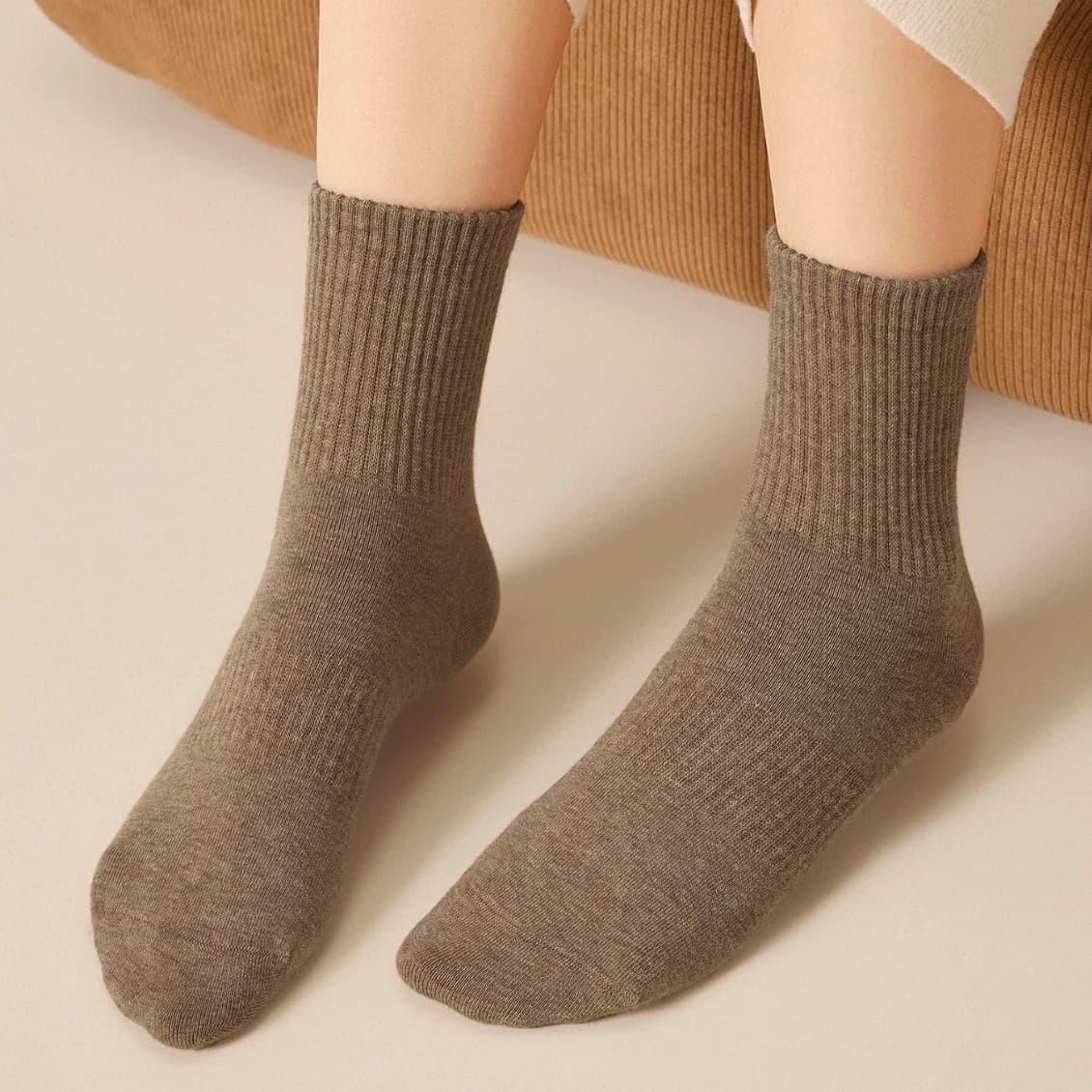 Brown ribbed cotton socks worn on both feet