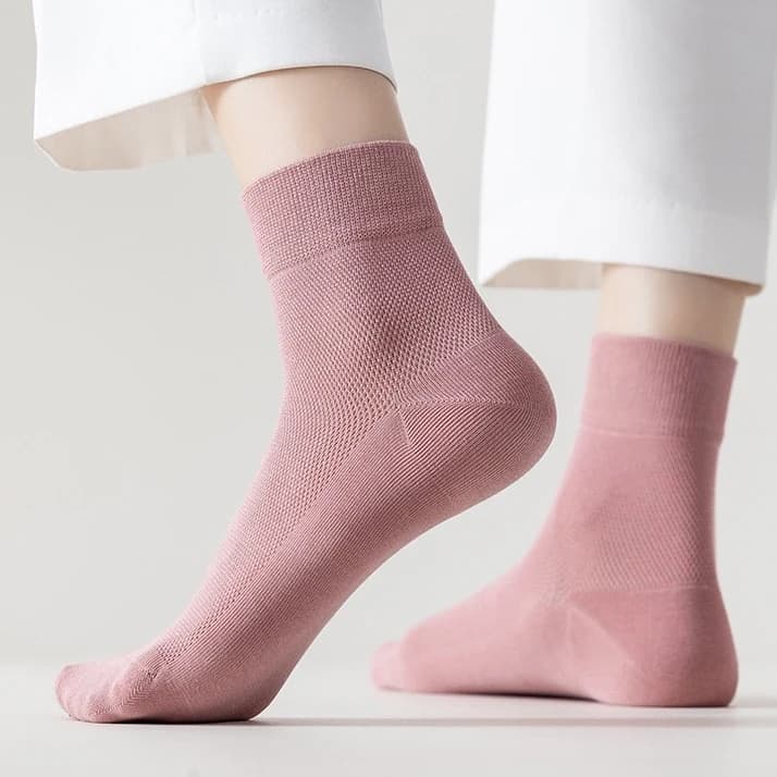 Dusty pink dress socks paired with white trousers