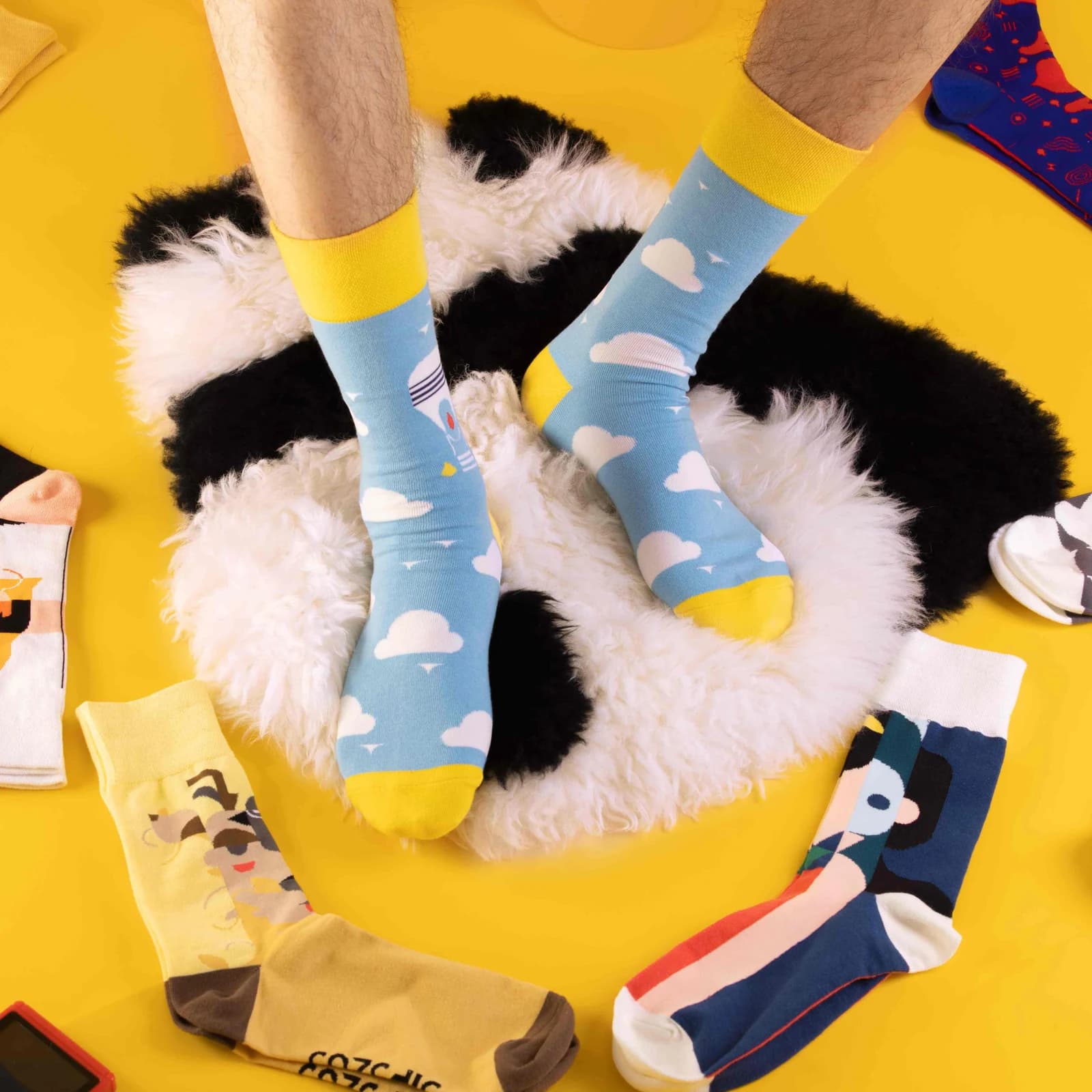 Colorful patterned socks worn against a yellow background
